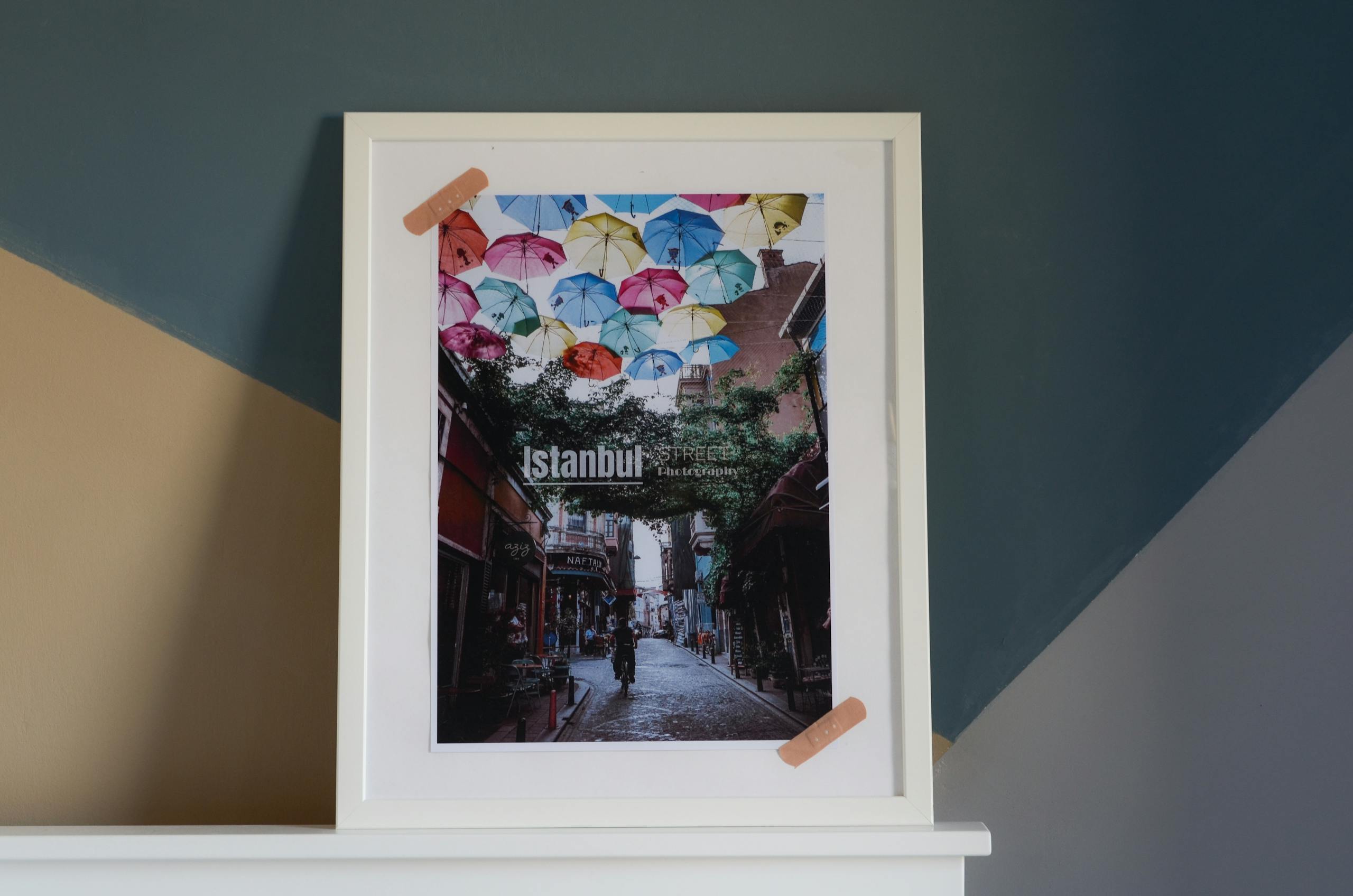 Framed photo of Istanbul street scene with vibrant umbrellas, perfect for home decor.